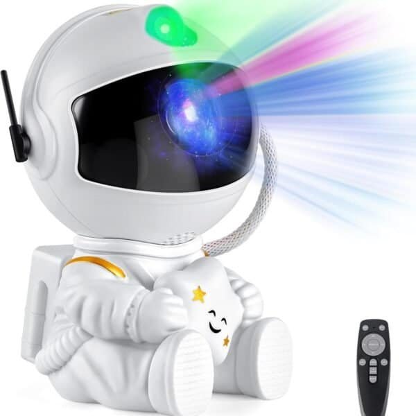 A small astronaut-shaped projector emits colorful light patterns from its helmet; a remote control is placed beside it.