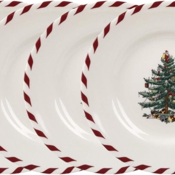 Four white plates with red striped rims, each decorated with a Christmas tree and presents in the center.