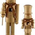 Two gold-painted wooden nutcracker figures, one taller with a crown and a tree, the other shorter with a top hat, both standing on rectangular bases and wearing brown ribbon bows.