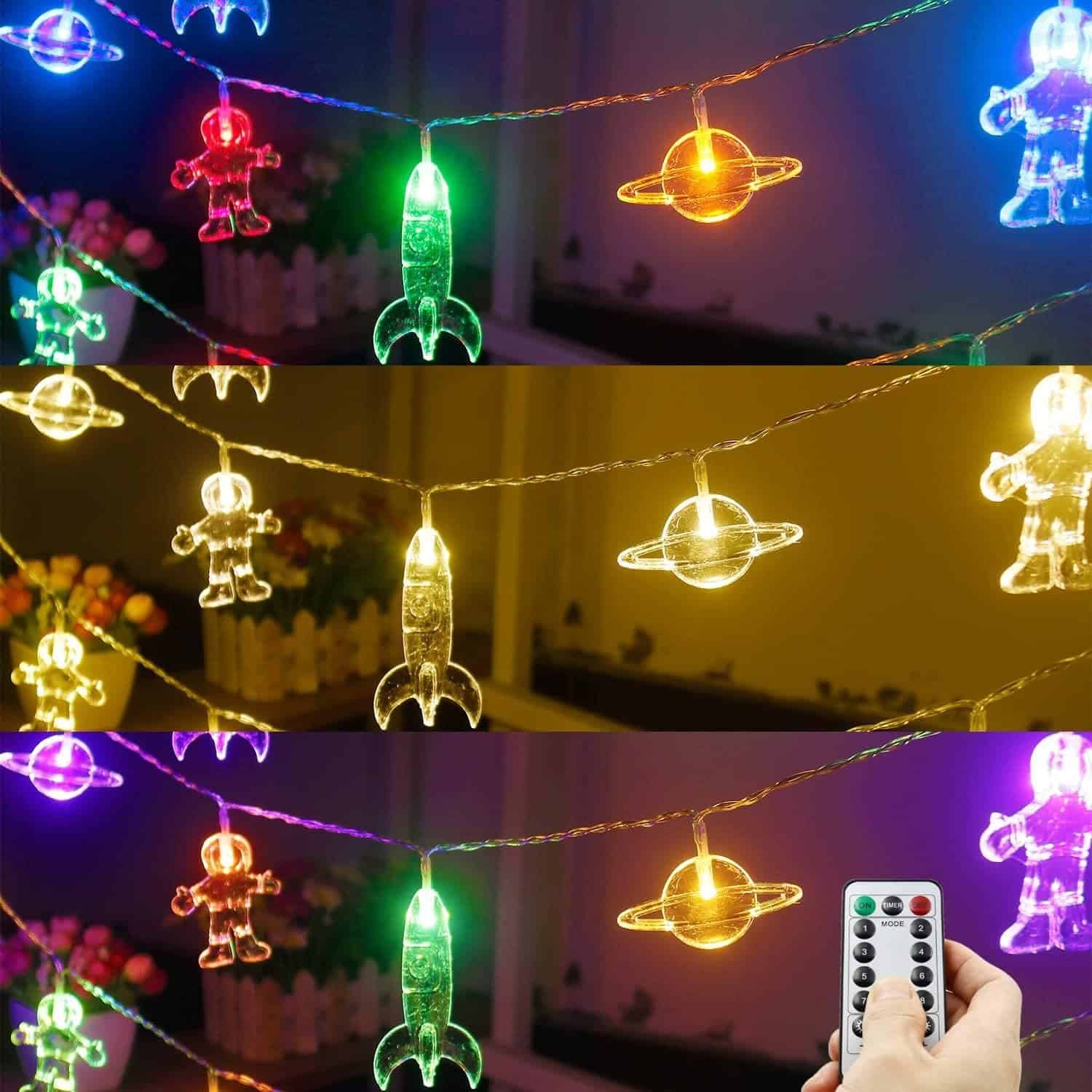 String lights shaped like astronauts, rockets, and planets in various colors, with a hand holding a remote control, displayed in three lighting modes.