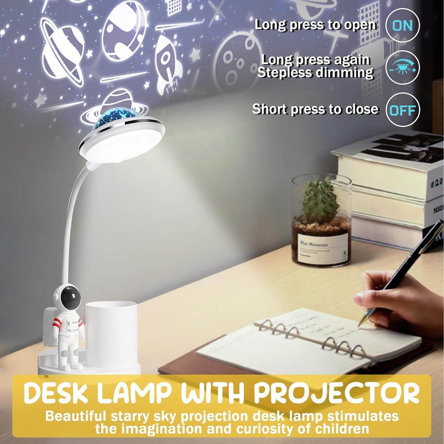 A desk lamp with a built-in projector displays a starry sky on the wall. Instructions for operation are shown, and a child’s hand is writing in a notebook on the desk.
