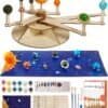 A DIY solar system model kit with painted and unpainted planet spheres, brushes, paint pots, wooden assembly pieces, instruction cards, and a colorful planet mat displayed.