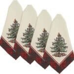 Four cream-colored Christmas napkins featuring a decorated Christmas tree and a red plaid border, arranged in a fanned-out pattern.