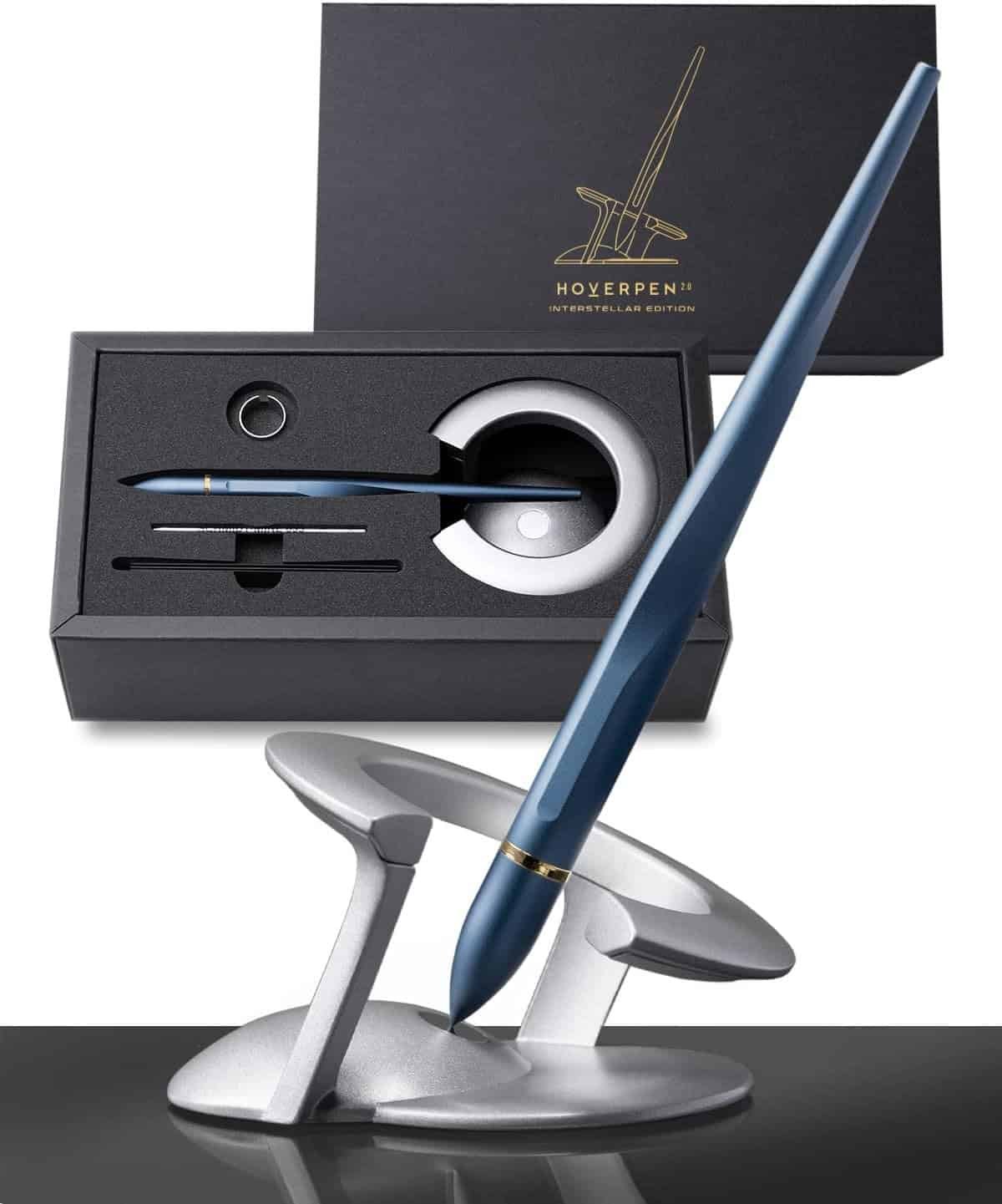 A blue pen hovering upright on a silver magnetic stand, with its packaging box and pen accessories displayed in the background.