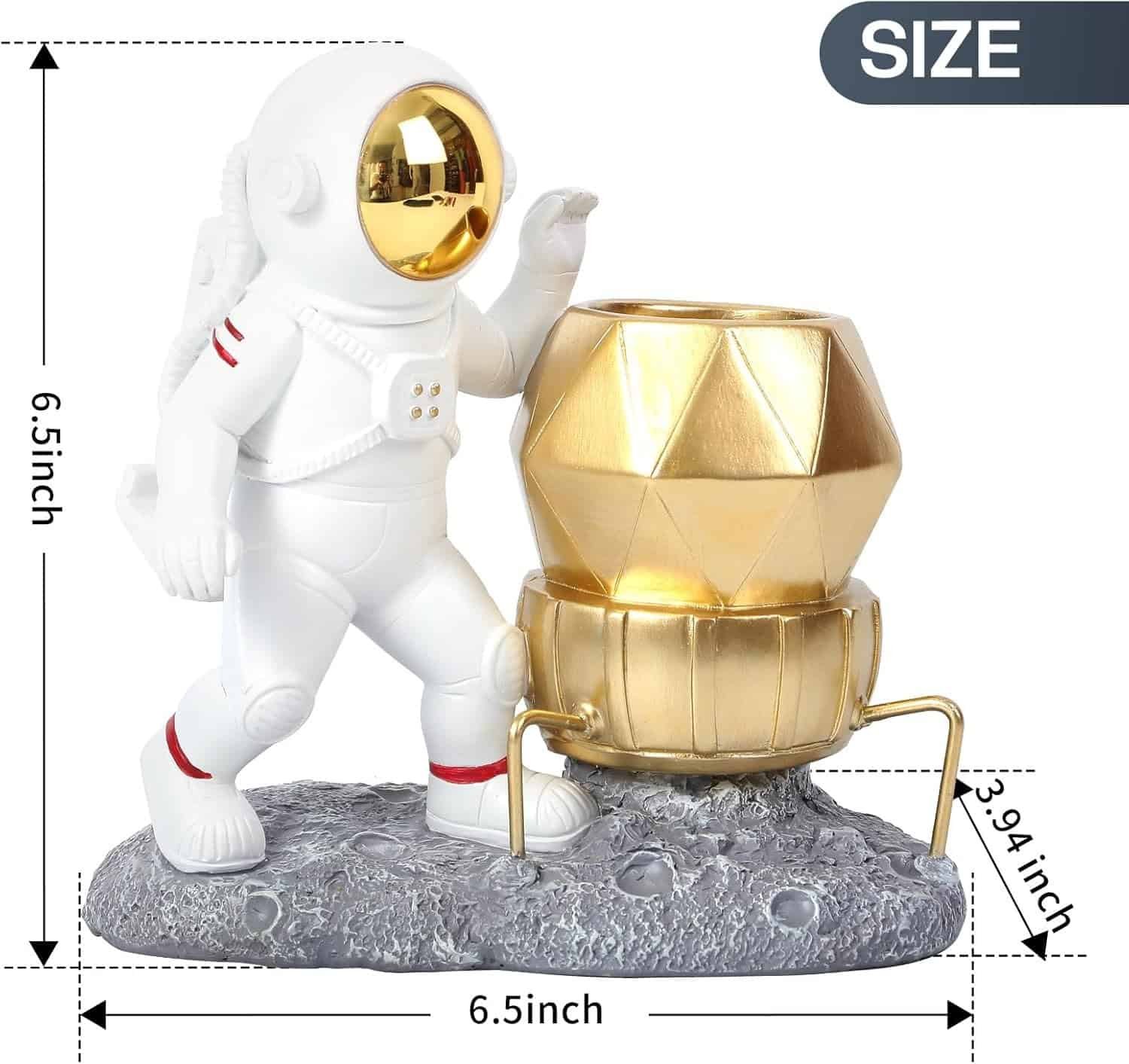 A small astronaut figurine stands on a textured gray base beside a gold geometric container, with size dimensions 6.5 x 6.5 x 3.94 inches marked around the object.