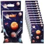 A set of party favor bags with a space-themed design, featuring planets, stars, and rockets on a dark background.