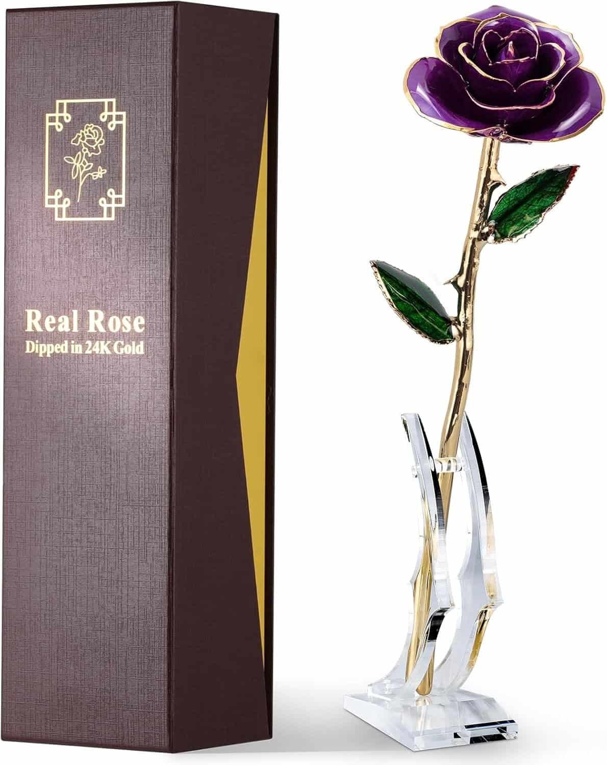 A purple preserved rose with gold detailing on a clear stand is displayed next to a brown gift box labeled "Real Rose Dipped in 24K Gold.