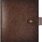 A closed, brown leather notebook with a strap and button clasp on the right side.