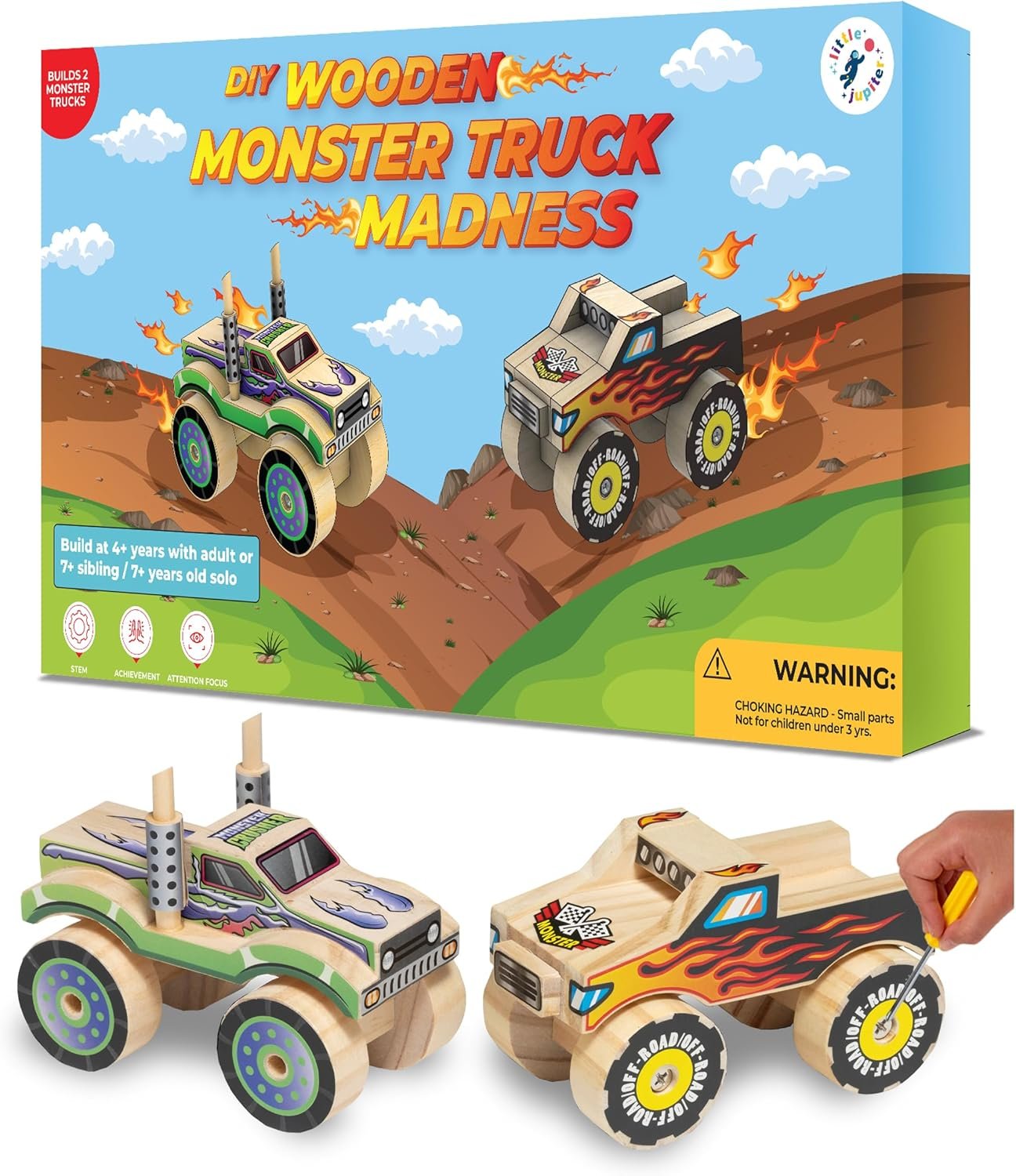 A DIY wooden monster truck kit with two assembled toy trucks in front of a colorful box labeled "Monster Truck Madness" for children ages 4 and up.