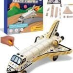 DIY wooden space shuttle kit includes a model space shuttle, assembly parts, mini tools, and illustrated packaging showing a completed shuttle. Suitable for children aged 4 and up.