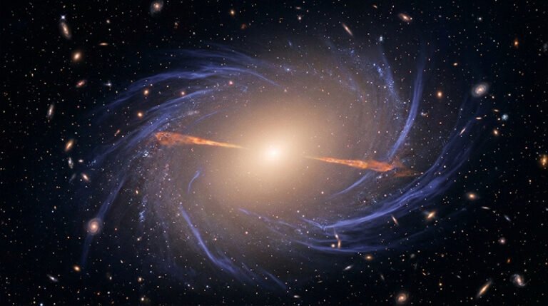 A bright galaxy at the center emits light, with spiral arms and numerous smaller galaxies, red geyser galaxies, and stars scattered throughout the dark space background.