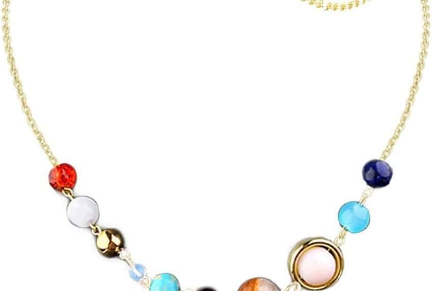 Gold chain necklace featuring colorful beads arranged to resemble the planets of the solar system, with a small green star charm near the clasp.