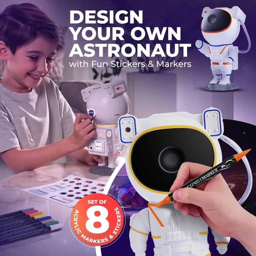 A child decorates a toy astronaut using markers and stickers. The image promotes a set of 8 acrylic markers and stickers for customizing the astronaut figure.