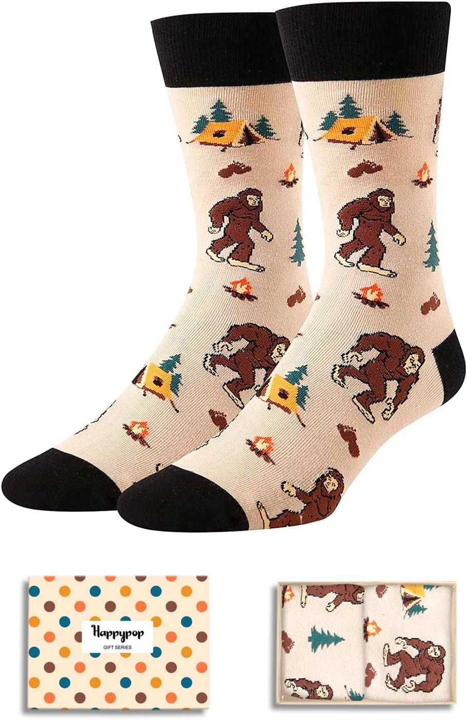 A pair of beige socks with black cuffs featuring Bigfoot, trees, tents, and campfires; shown with a polka dot gift box.
