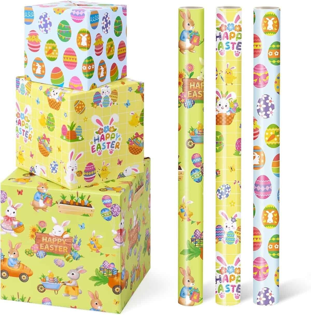 Three wrapped boxes and four rolls of Easter-themed wrapping paper with designs featuring bunnies, Easter eggs, and "Happy Easter" text on pastel backgrounds.