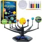National Geographic Glow-in-the-Dark Solar System Activity Kit with model planets, paint palette, brush, and colored paints displayed.