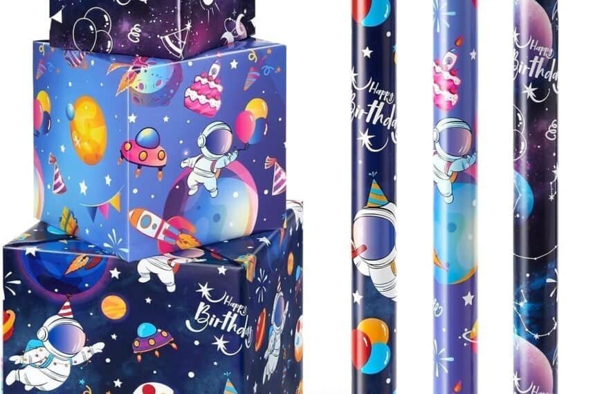 Three wrapped gift boxes and four rolls of space-themed birthday wrapping paper featuring astronauts, planets, and “Happy Birthday” text on a starry background.