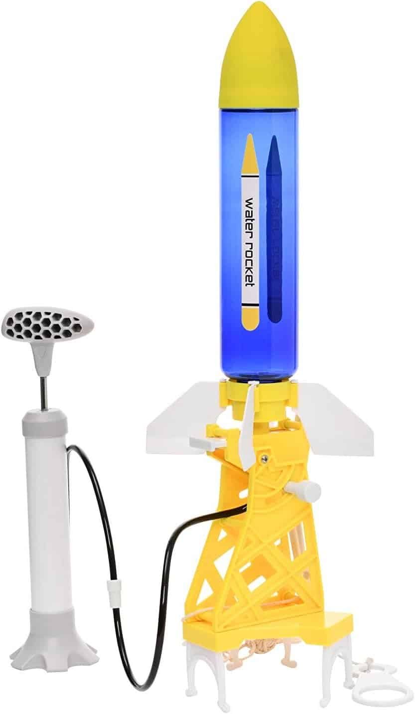 A plastic water rocket toy set with a blue and yellow rocket, a white and gray foot pump, and yellow launch pad connected by a black tube.