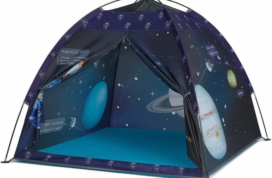 A children’s play tent with space-themed graphics including planets, spacecraft, and dates, set up on a blue floor.