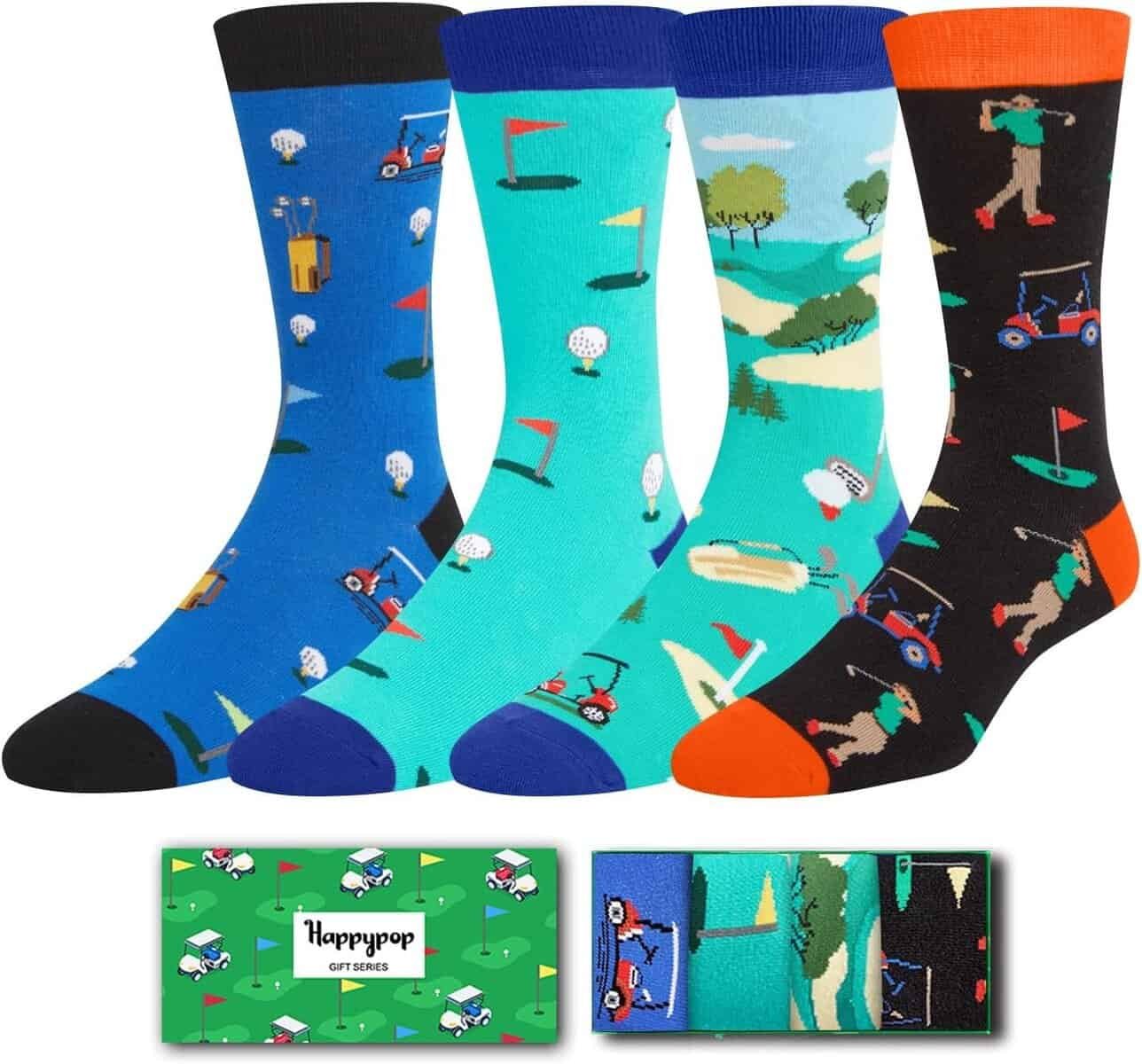 Four pairs of colorful golf-themed socks with various patterns, displayed next to a green HappyPop gift box featuring golf graphics.