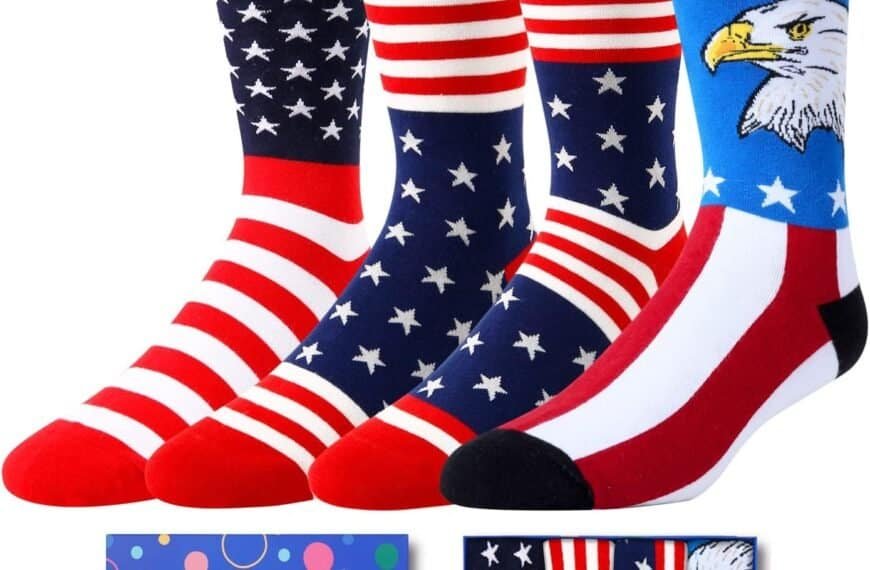 Four pairs of socks with American flag and bald eagle designs are displayed above a blue HappyPop gift box.