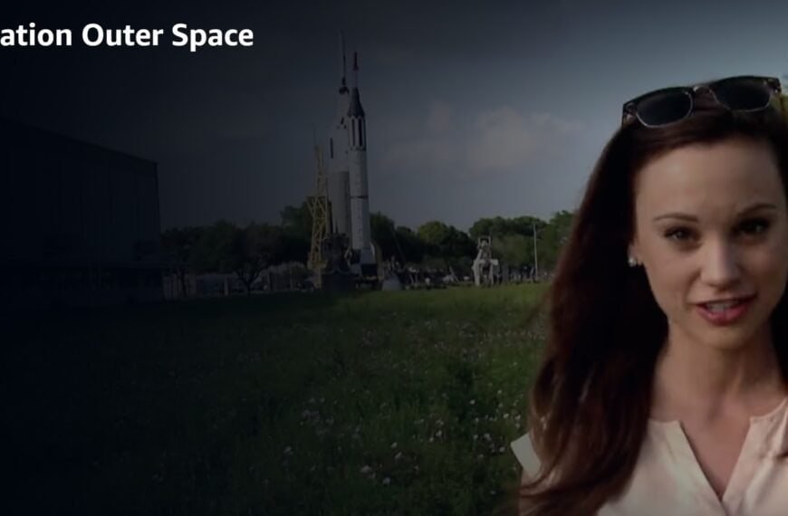 A woman stands outdoors in front of a rocket display, with the Watch Xploration Outer Space | Prime Video logo in the top left corner.