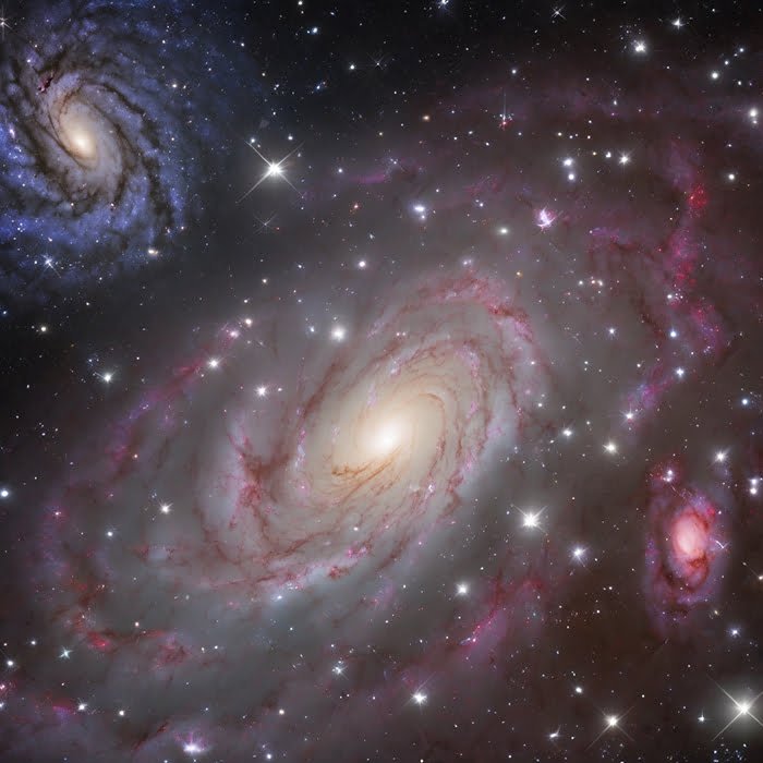 Understanding Galaxies, what is the definition of a galaxy 2 A vivid astronomical image showing a spiral galaxy with prominent arms, swirling dust, and bright star clusters, set against a backdrop of deep space.