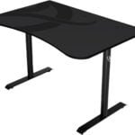 A black, minimalist desk with a curved edge and dual metal legs.