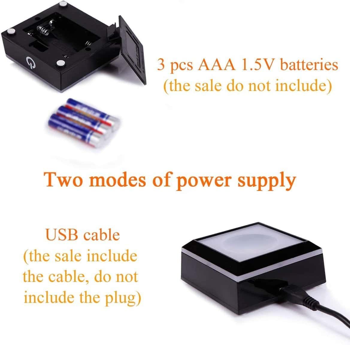 A black device with removable battery compartment and USB port. Text indicates it uses 3 AAA batteries (not included) or a USB cable (included, excluding plug) for power.