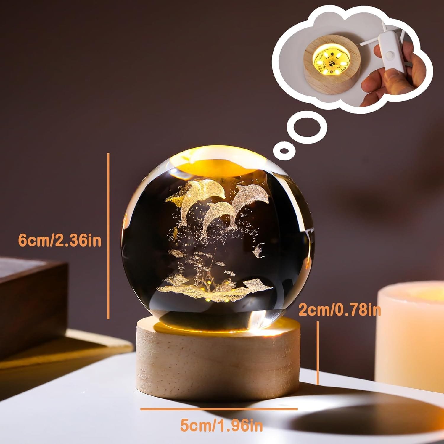 A glowing crystal ball on a wooden base, with dimensions labeled: height 6cm, width 5cm, depth 2cm. A thought bubble shows a hand holding an illuminated base.