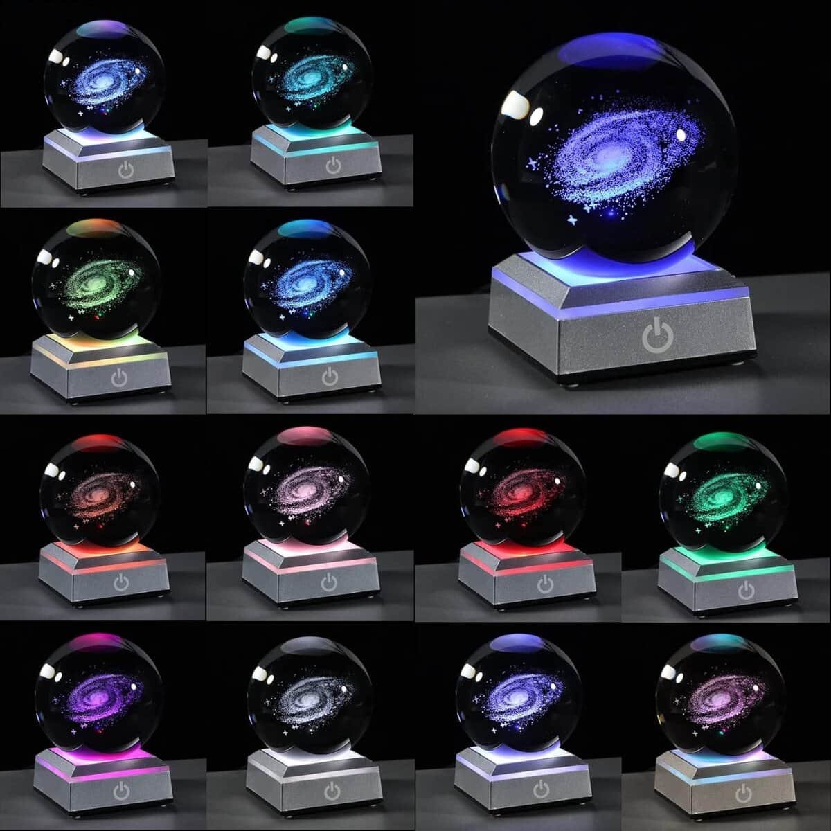 Crystal globe featuring a galaxy design on a base, shown in various colored lights.