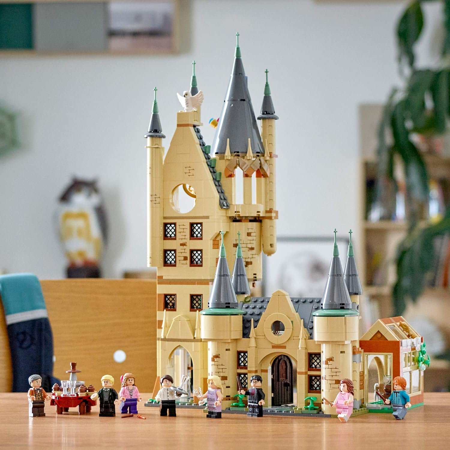 Lego Hogwarts castle set with minifigures from the Harry Potter series displayed on a table.