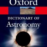 Cover of "Oxford Dictionary of Astronomy" by Ian Ridpath, featuring a solar eclipse and landscape with satellite dishes.