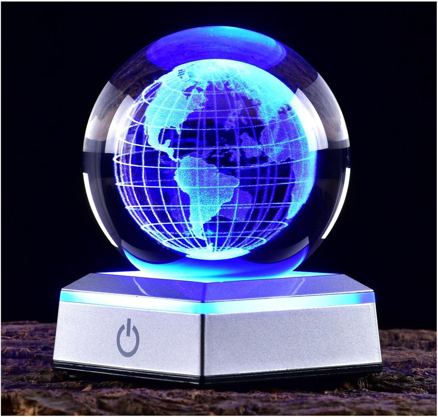 A glowing blue crystal globe with a map design sits atop a silver base with a power button.