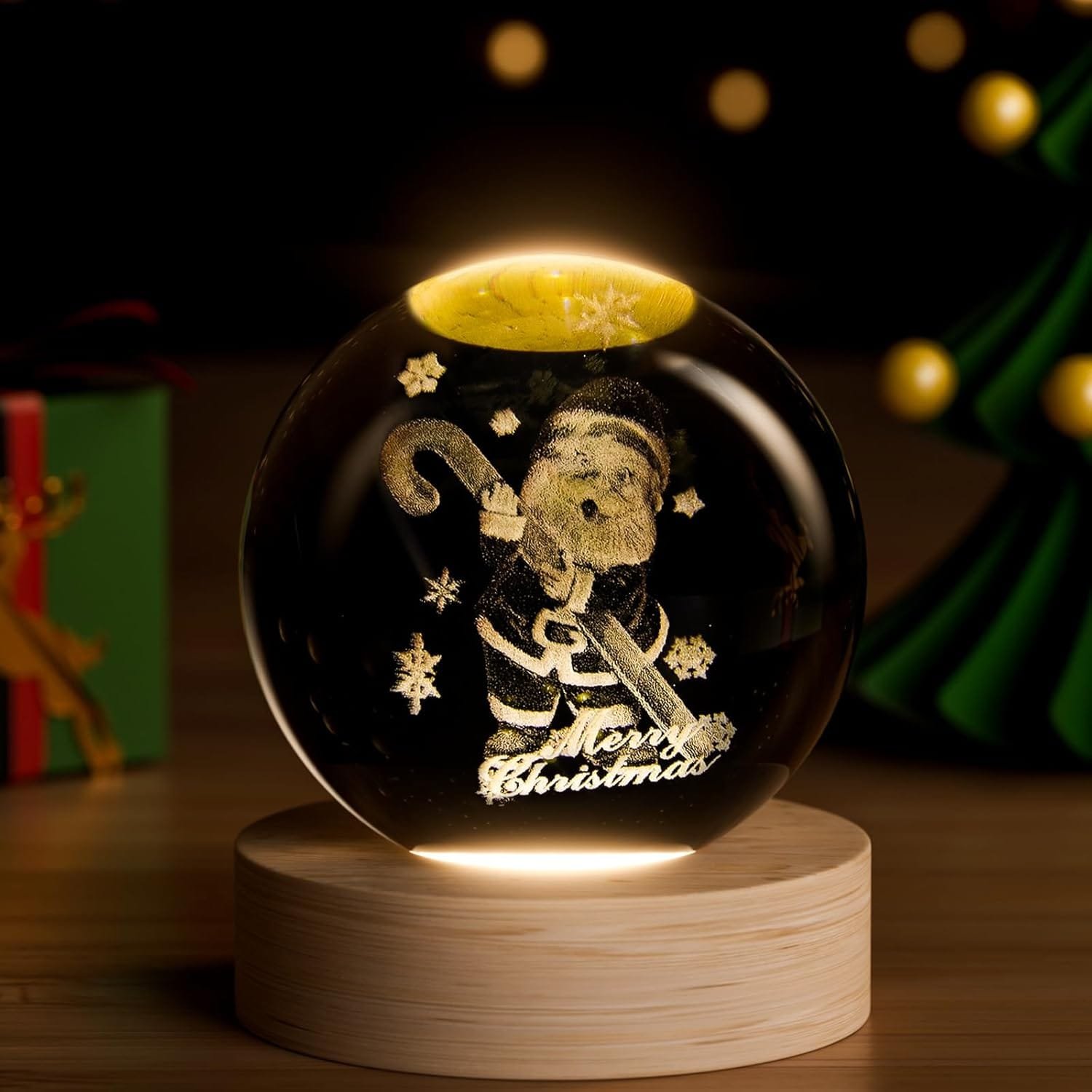 A glowing snow globe with a Santa Claus figure, holding a candy cane and the words "Merry Christmas," on a wooden base.