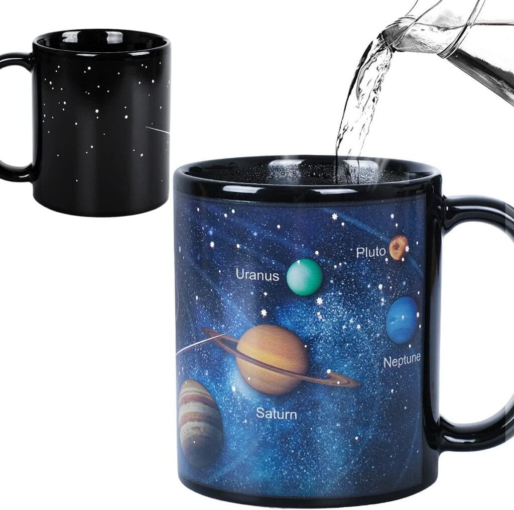 A black mug with stars reveals a solar system design with planets labeled when hot water is poured in.