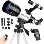 Telescope on a tripod with accessories including lenses, a smartphone adapter, and a remote control. A moon image is visible on a smartphone screen.