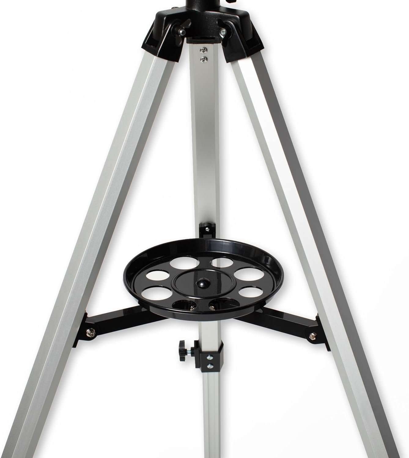 Close-up view of a silver tripod with a black circular accessory tray attached between the legs.