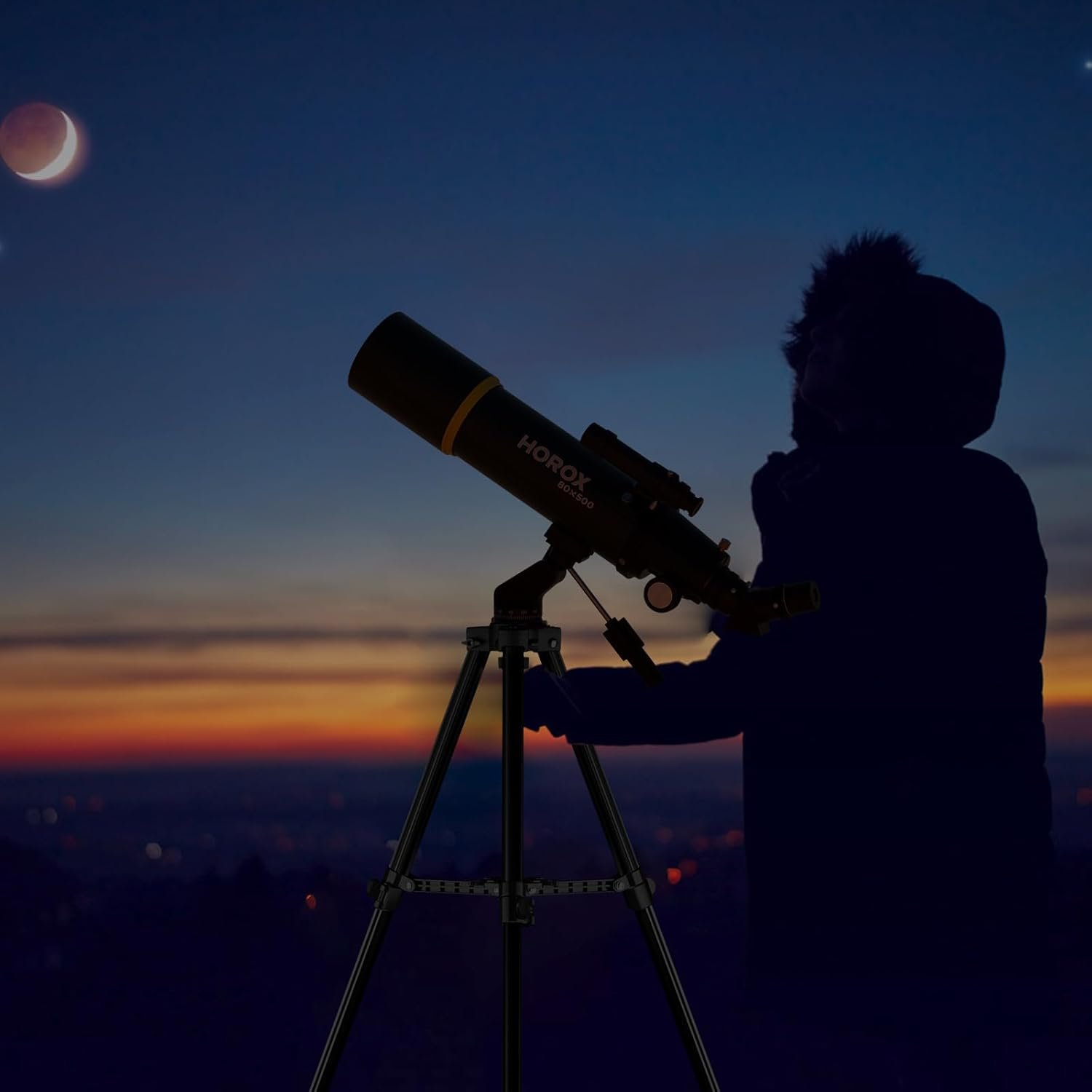A person in a hooded jacket uses a HOROX telescope on a tripod at dusk, with a crescent moon and a bright object visible in the sky.