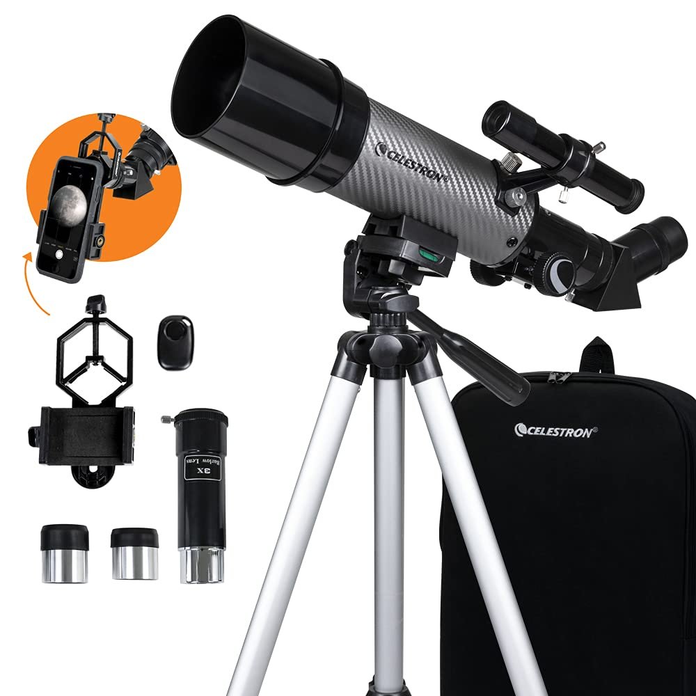 A Celestron telescope on a tripod with accessories including eyepieces, a smartphone adapter, a finderscope, a lens, and a carrying case.
