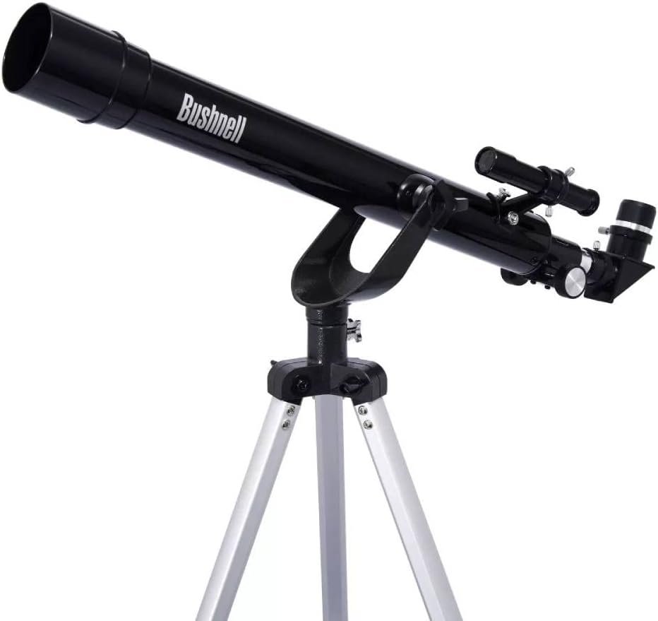 A black Bushnell telescope mounted on a silver tripod, featuring adjustment knobs and a small finderscope.