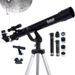 A black Bushnell telescope on a tripod is shown with various eyepieces, lenses, and accessories; a large image of the moon is in the background.