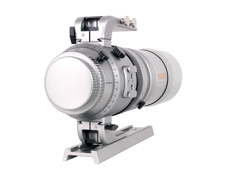 A silver and white camera lens with a tripod mount collar, adjustment dials, and measurement markings, positioned on a white background.