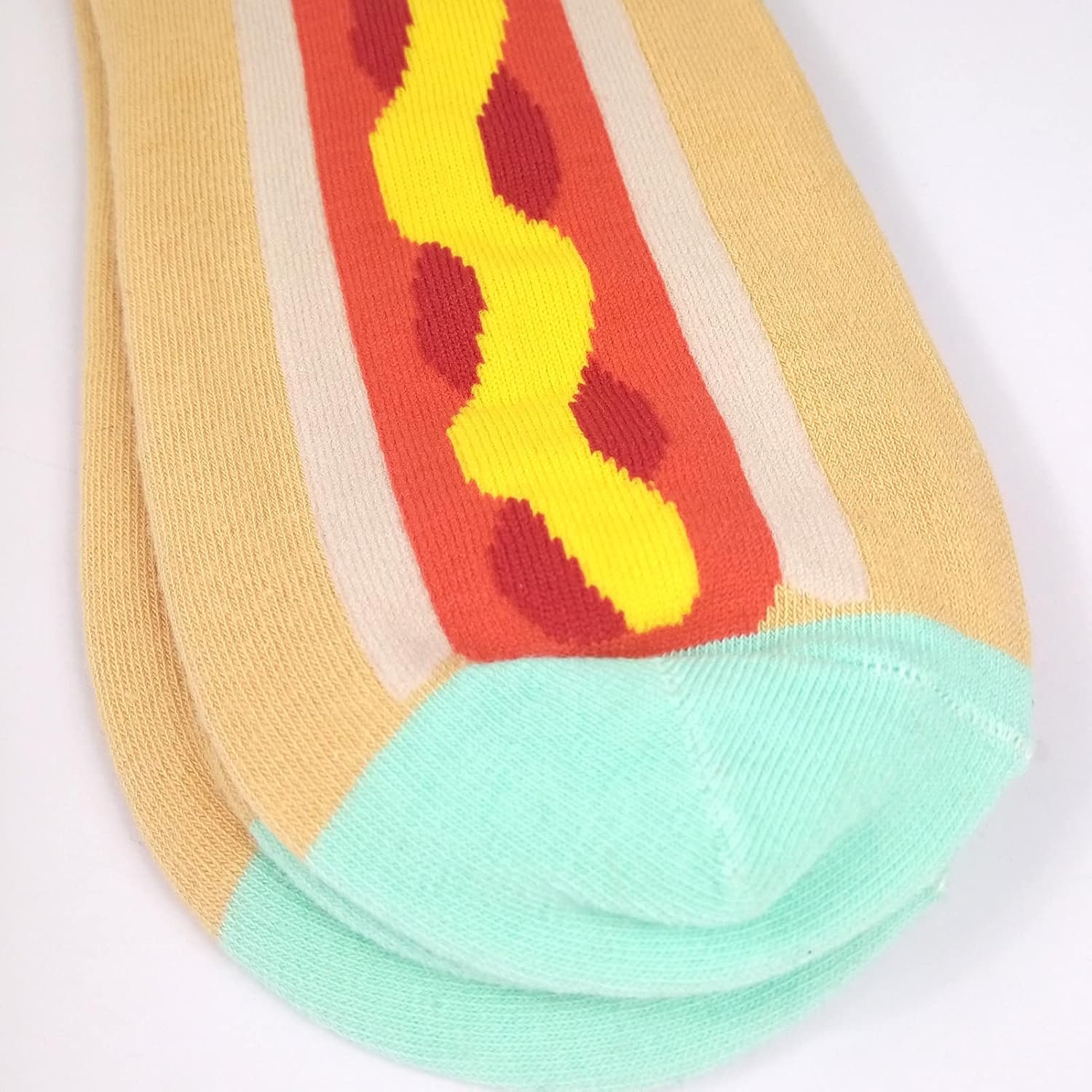 A pair of socks designed to look like a hot dog with mustard, featuring beige, red, yellow, and light blue colors.