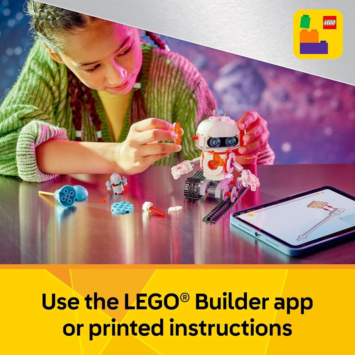 A child assembles a LEGO robot using parts, with printed instructions and a tablet displaying digital instructions on a table.