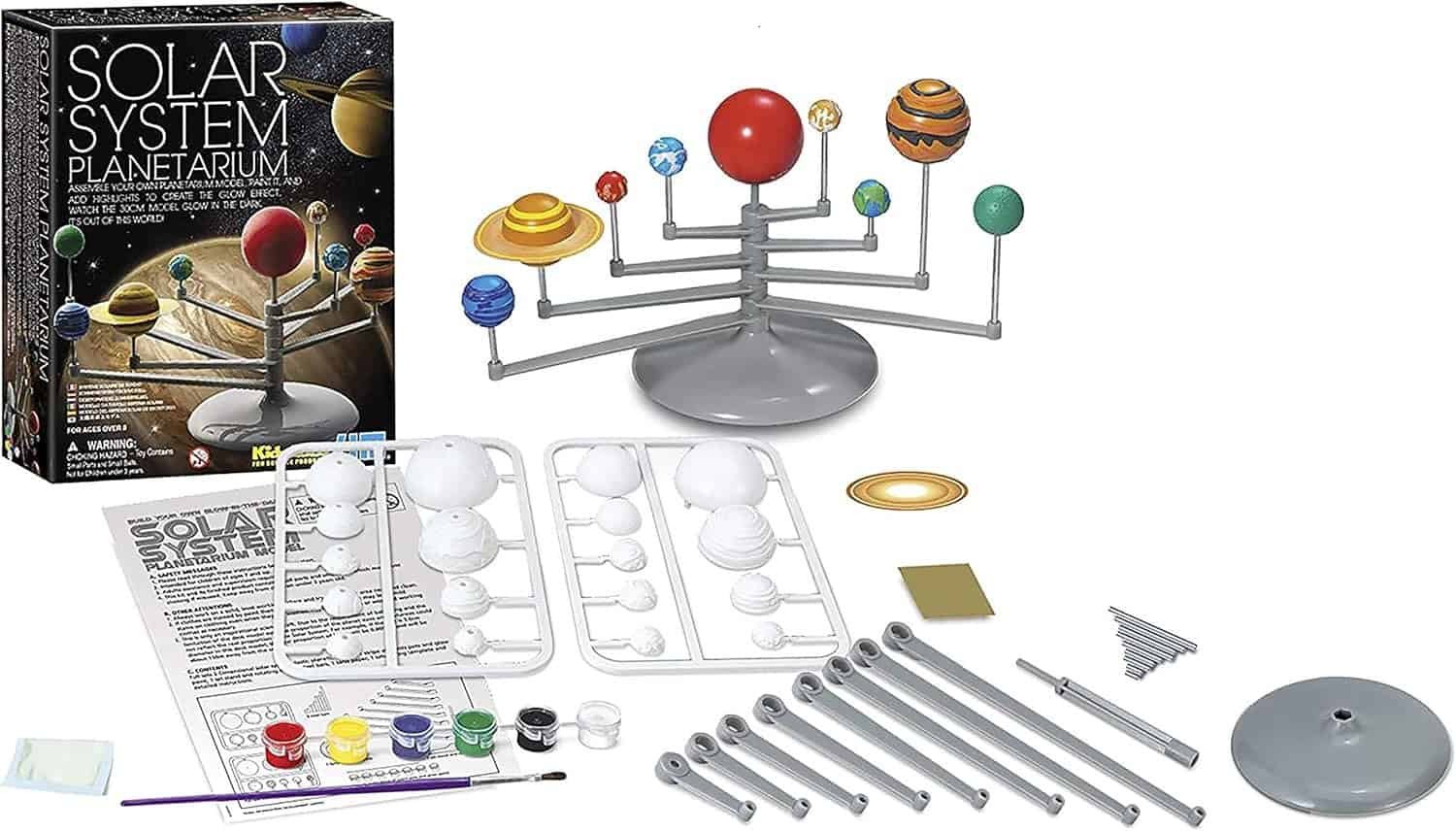 Solar System planetarium model kit with assembled and unassembled parts, paint, brush, instructions, and packaging displayed on a white surface.