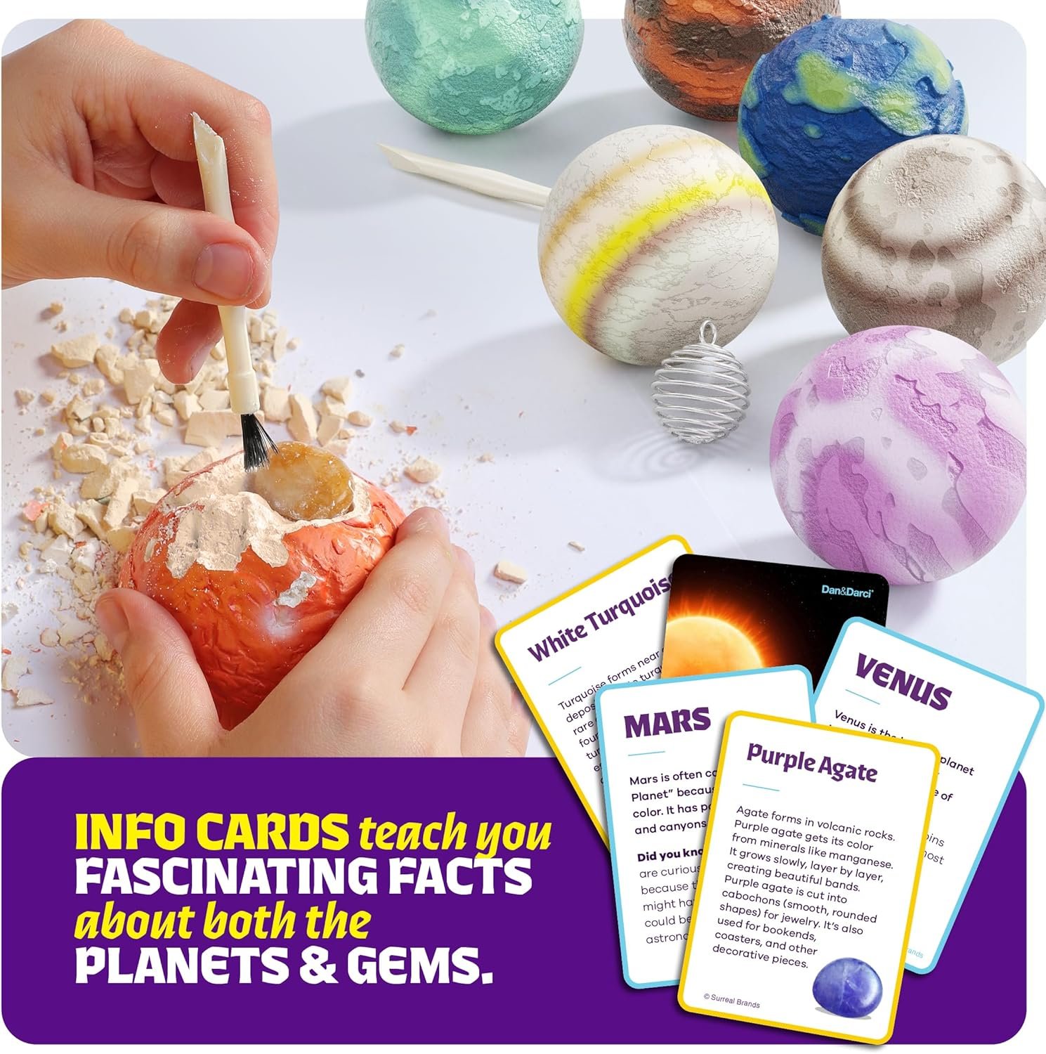 A hand uses a tool to dig into a model planet; painted planet models, info cards about planets and gems, and excavation debris are displayed on a white surface.