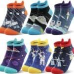 Six pairs of colorful ankle socks featuring various space-themed designs, including astronauts, rockets, spaceships, planets, and satellites.