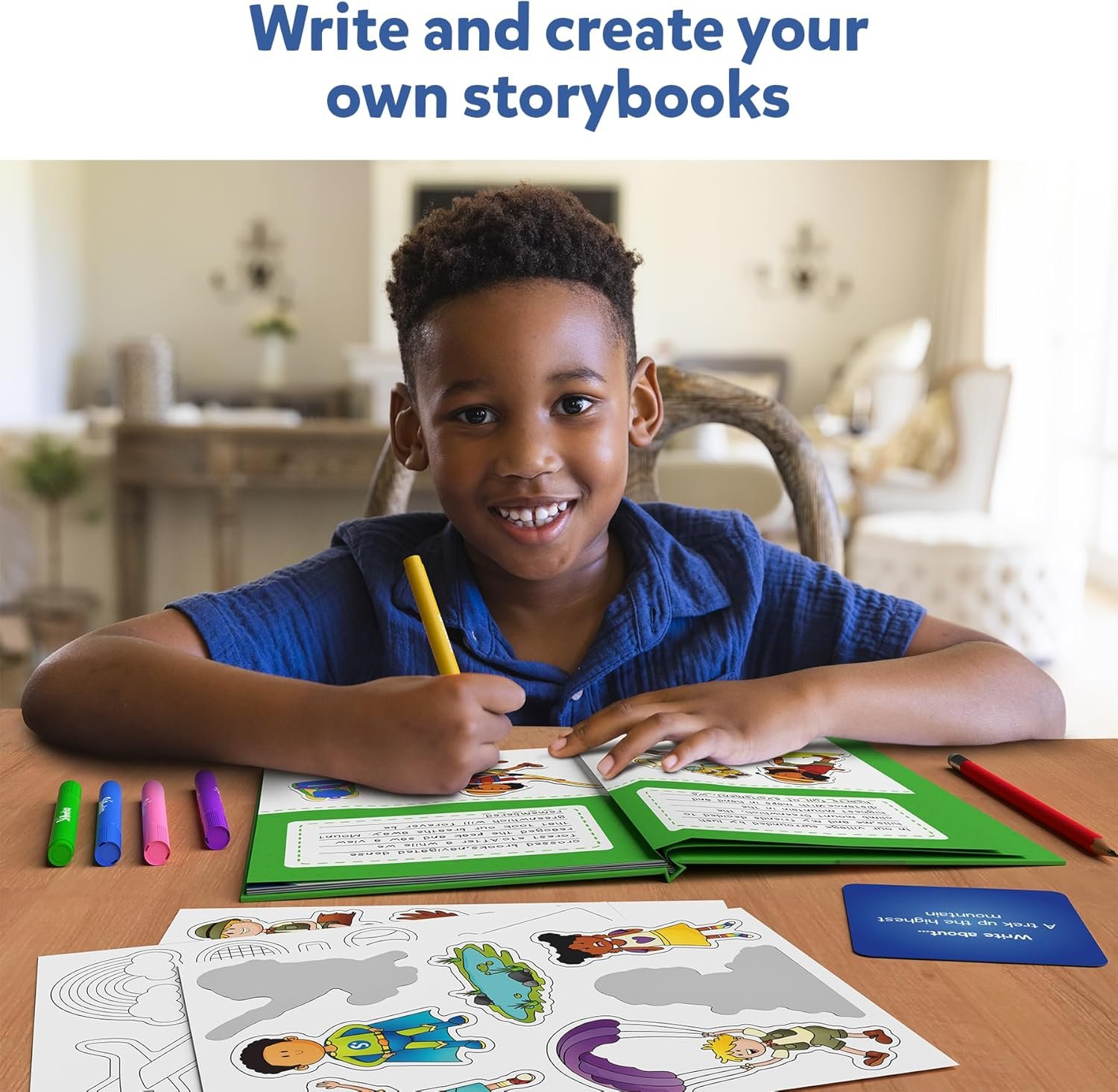 A child sits at a table coloring and writing in a storybook, with markers, stickers, and an open book on the desk. The background shows a living room setting.