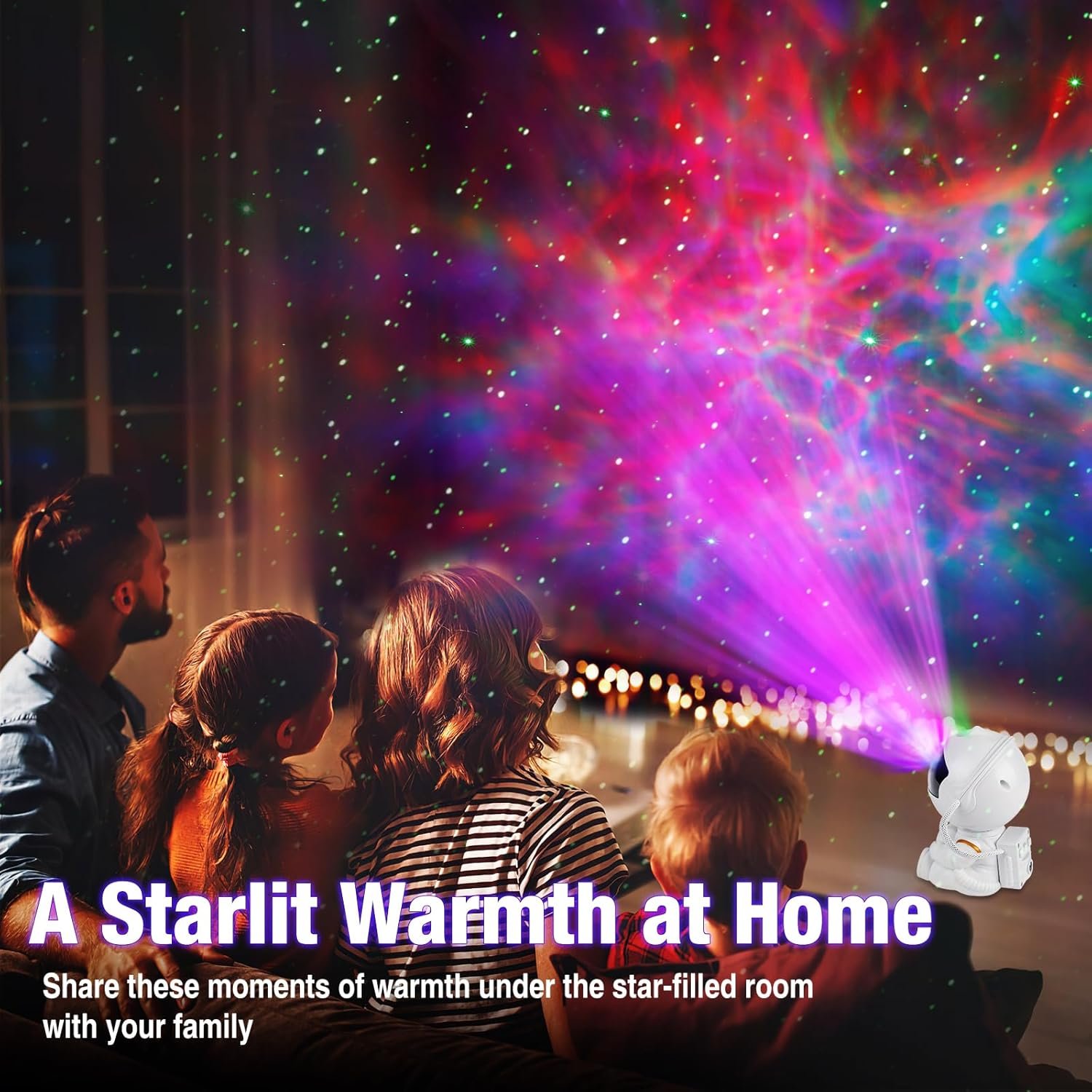 A family sits together indoors watching colorful star and galaxy lights projected onto the ceiling and walls by a small projector shaped like an astronaut.